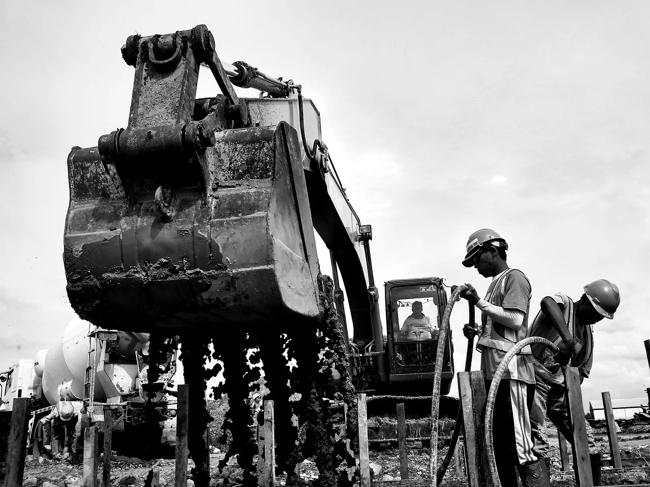 Excavator with construction workers on job site