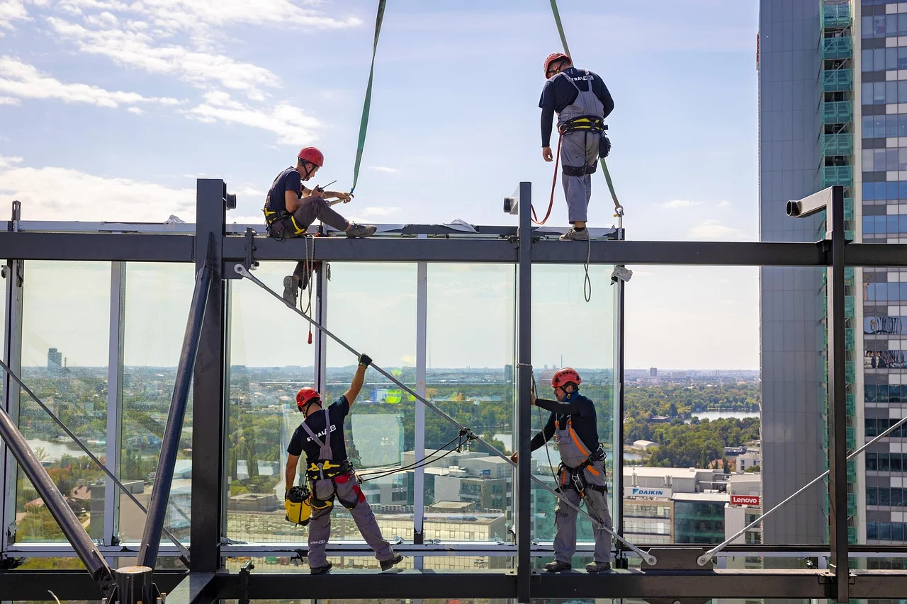 men at work with windows on construction site